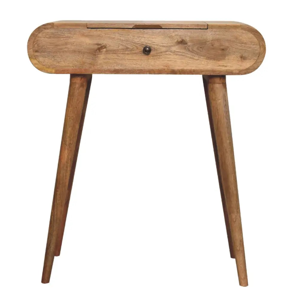 A rustic mini oak-ish round dressing table with a rounded top, single drawer, dark metal knob, and tapered legs