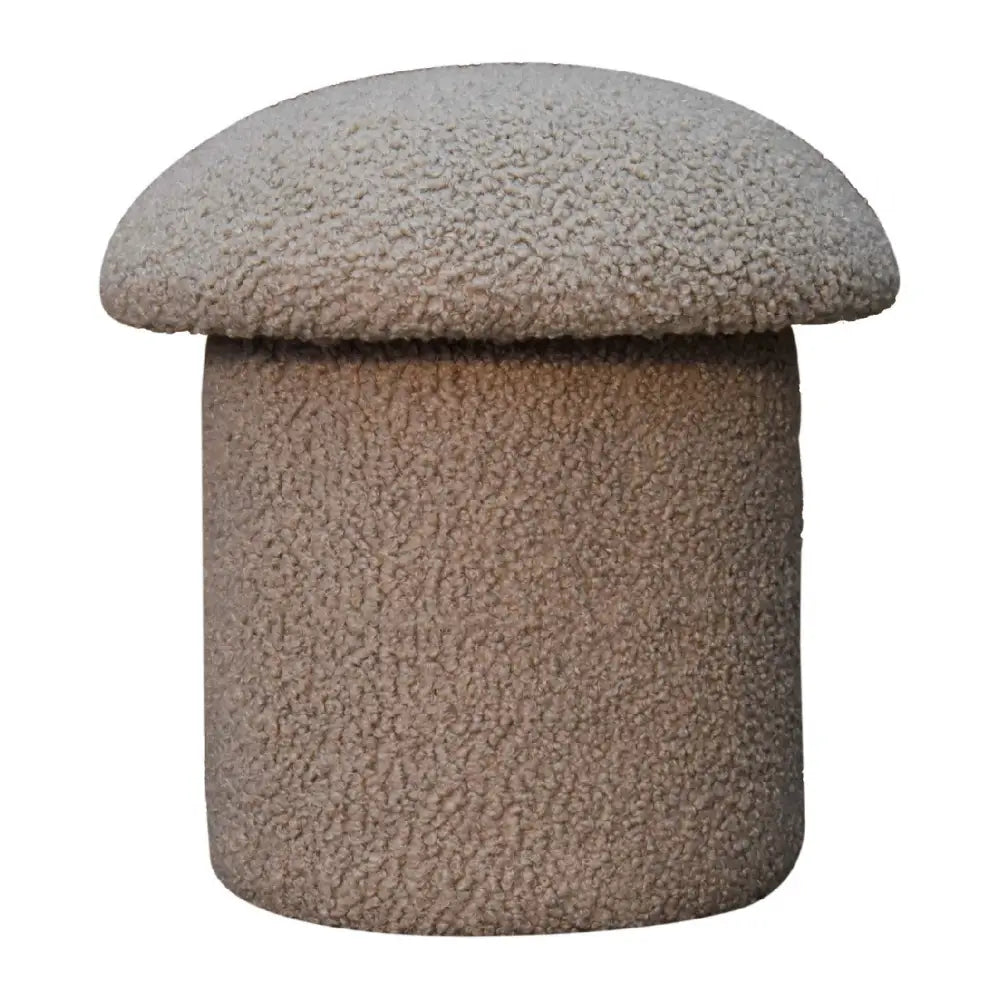 A cozy beige mud boucle mushroom footstool with a fuzzy rounded top and cylindrical base perfect for lounging