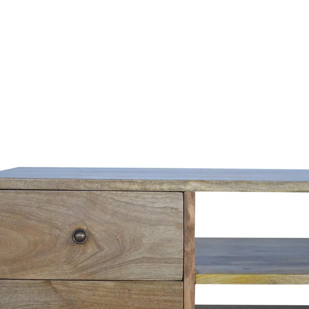 A rustic nordic entertainment unit with a light gray top natural wood grain drawers and round metal knobs