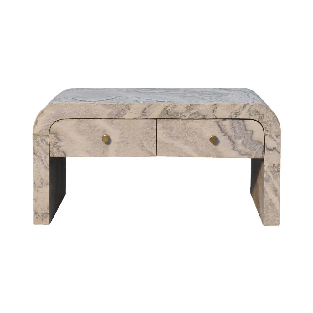 A sleek curved marble nightstand with two drawers and brass knobs perfect next to a nouveau coffee table