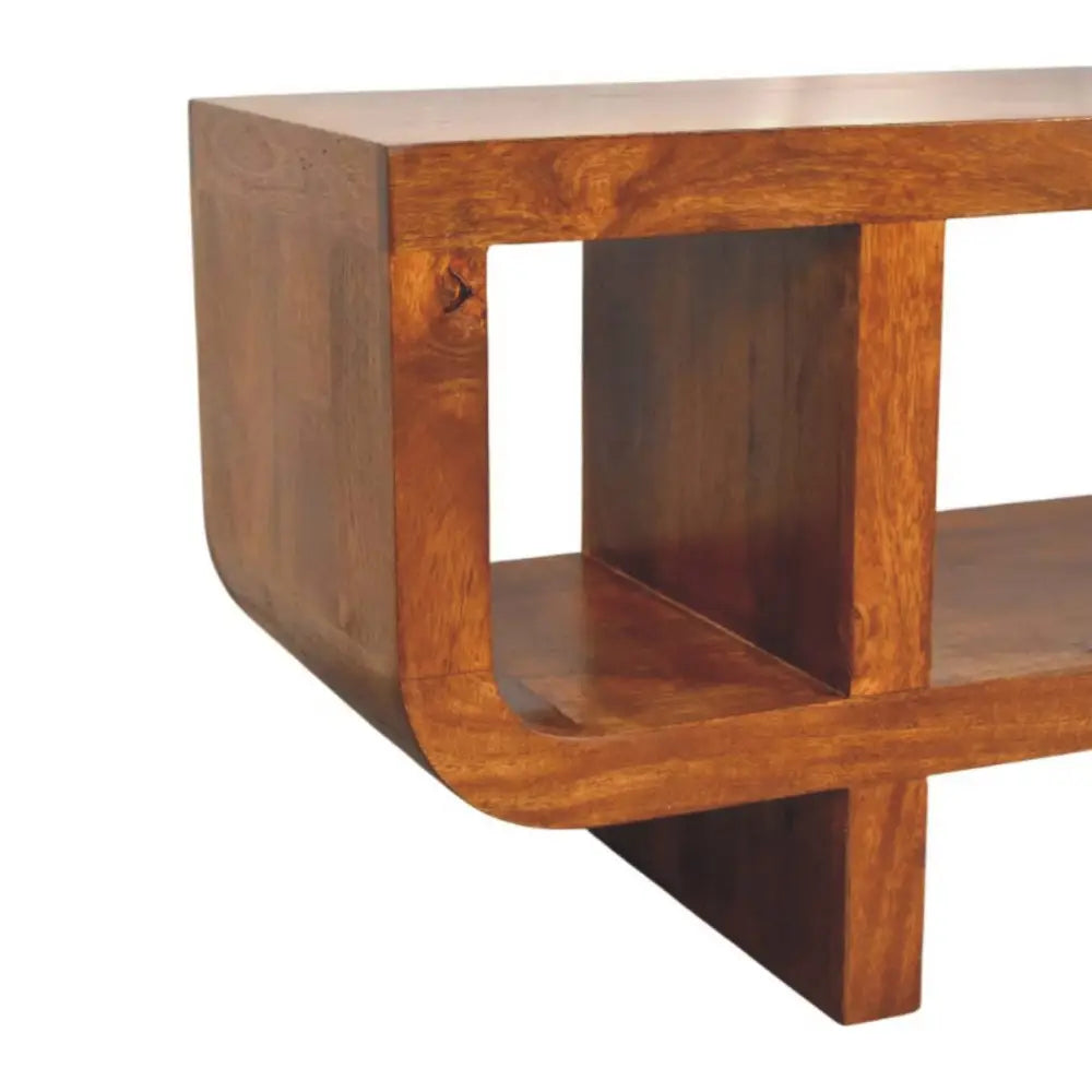 Solid mango wood coffee table with warm medium brown finish and smooth rounded edges in orion curved chestnut media unit