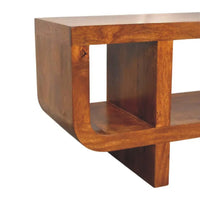Solid mango wood coffee table with warm medium brown finish and smooth rounded edges in orion curved chestnut media unit