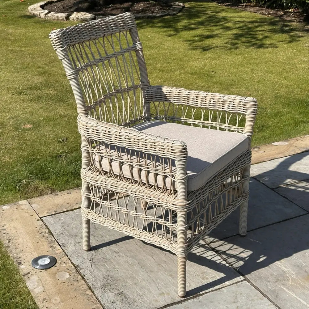 Beige wicker outdoor dining chair with light gray cushion from provence collection perfect for outdoor dining