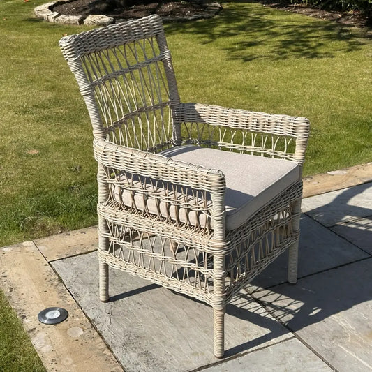 Beige wicker outdoor dining chair with light gray cushion from provence collection perfect for outdoor dining