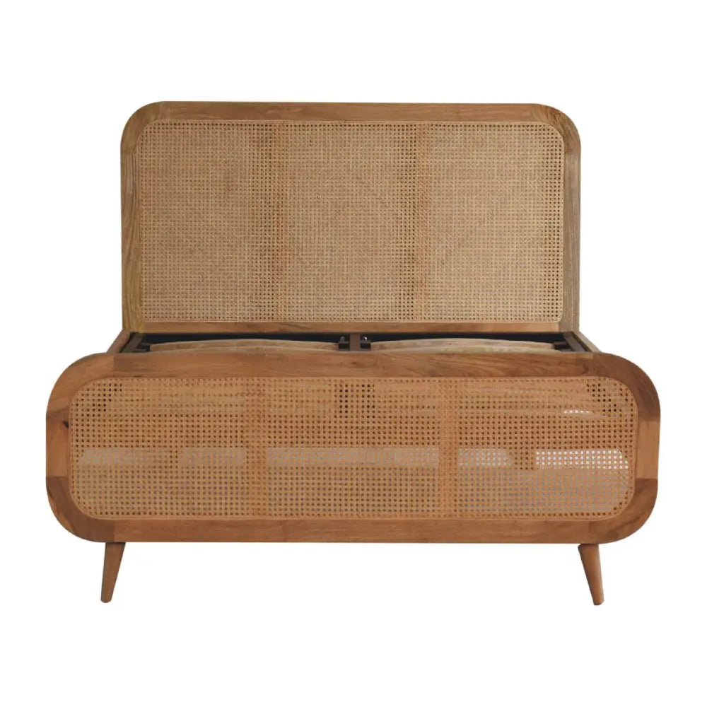 A mid-century modern rattan bed storage bench with light wood frame and woven cane panels on tapered legs