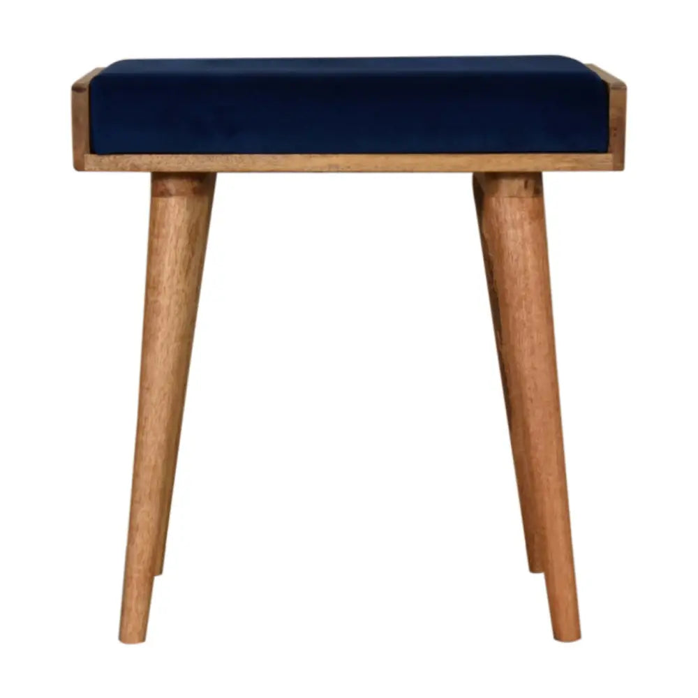 Royal blue velvet tray footstool with a navy blue cushioned seat and light wood tapered legs for stylish comfort