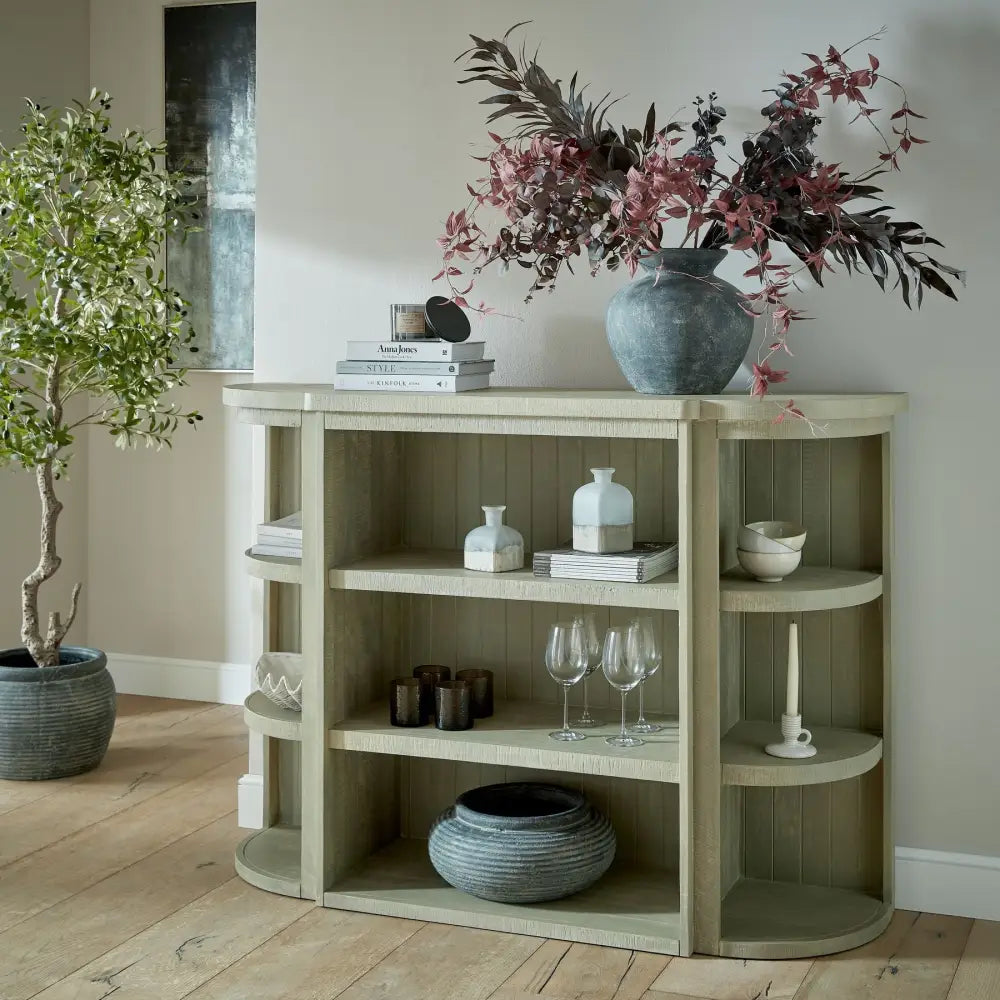 Saltaire collection 3-shelf sage green wooden console table with curved edges and blue-gray vase with dried foliage