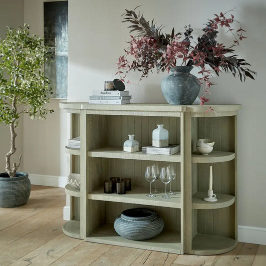 Saltaire collection 3-shelf sage green wooden console table with curved edges and blue-gray vase with dried foliage