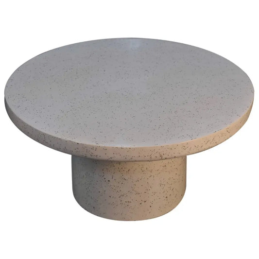 A sleek round serenity coffee table in speckled gray concrete with a matching cylindrical base perfect for any space