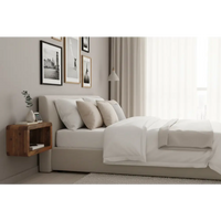 Beige upholstered bed with white bedding and pillows paired with a sleek soba wall mounted bedside unit