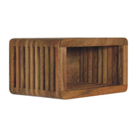A rectangular wooden wall mounted bedside shelf with vertical slats and a warm natural wood finish