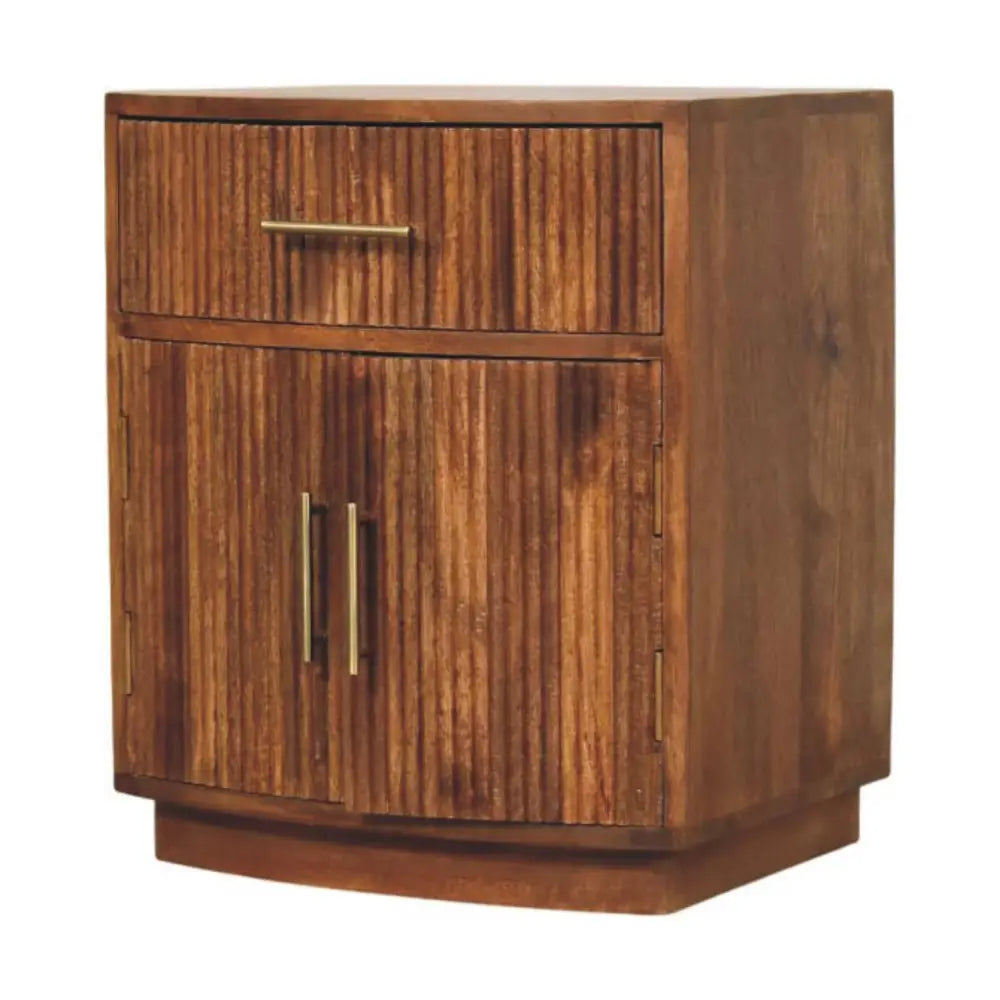 A rustic solid mango wood curved ribbed bedside with vertical slats, brass handles, drawer, and two doors