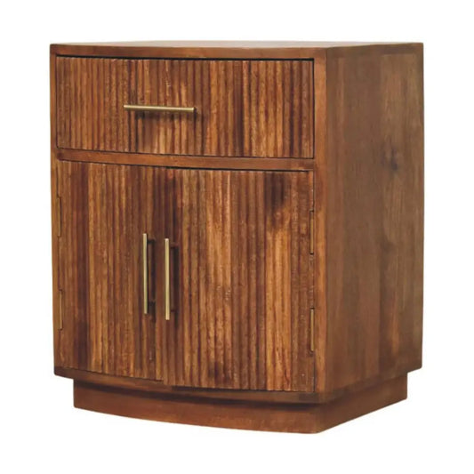 A rustic solid mango wood curved ribbed bedside with vertical slats, brass handles, drawer, and two doors