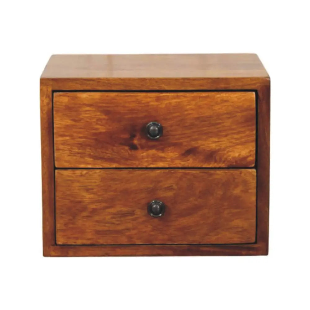 Solis 2-drawer chestnut wall mounted nightstand in solid mango wood next to a bed with white linens and mustard-yellow throw