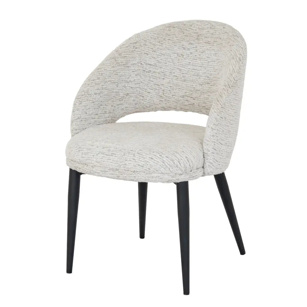 A sorelle curved dining chair with light gray textured upholstery and sleek black tapered legs perfect for dining rooms