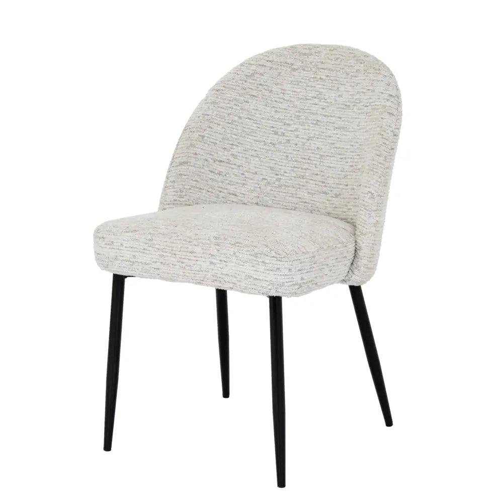 A sorelle dining chair with curved back and seat upholstered in textured light gray fabric and black metal legs