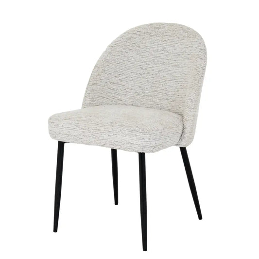 A sorelle dining chair with curved back and seat upholstered in textured light gray fabric and black metal legs