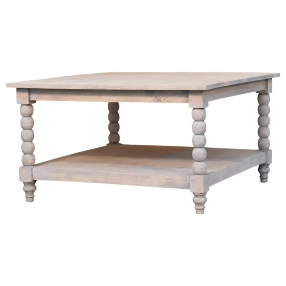 A rustic spindle acid wash coffee table in light gray wood with turned bead legs and a lower shelf
