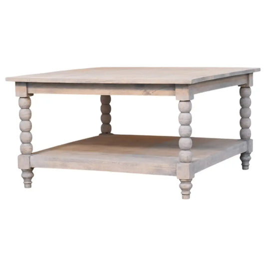 A rustic spindle acid wash coffee table in light gray wood with turned bead legs and a lower shelf