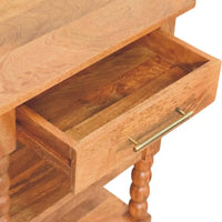 Light brown solid mango wood spindle side table with single drawer and brass handle on turned wood legs