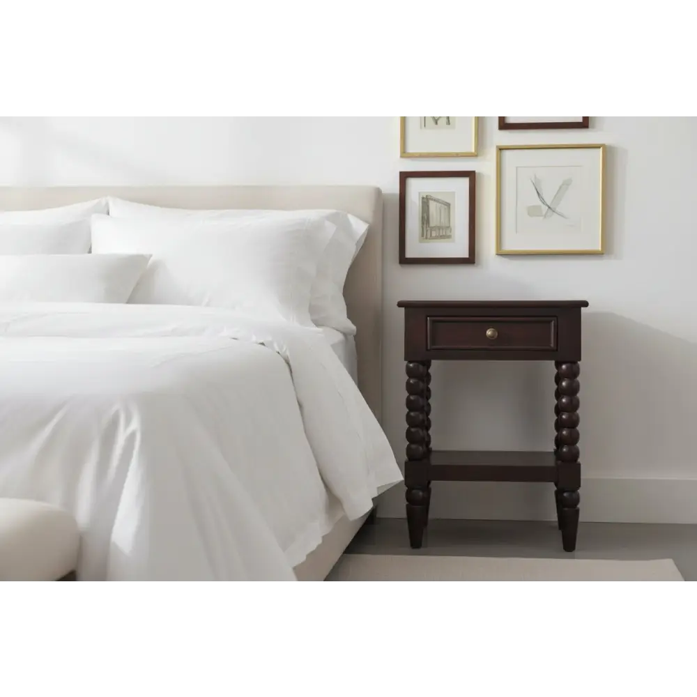 Dark wood spindle winewood bedside nightstand with turned legs and a single drawer for bedroom storage