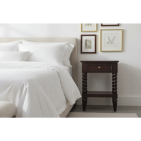 Dark wood spindle winewood bedside nightstand with turned legs and a single drawer for bedroom storage
