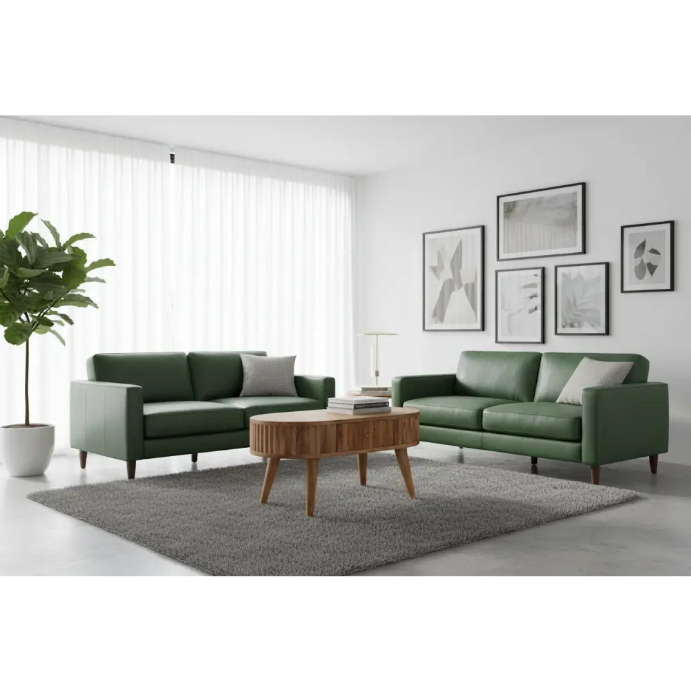Green leather sofa with gray throw pillows next to a modern stripe coffee table in a cozy living room setup