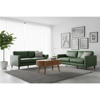 Green leather sofa with gray throw pillows next to a modern stripe coffee table in a cozy living room setup