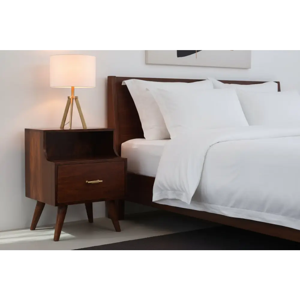 T-bar raised bedside nightstand in dark wood with tapered legs and a brass handle on one drawer