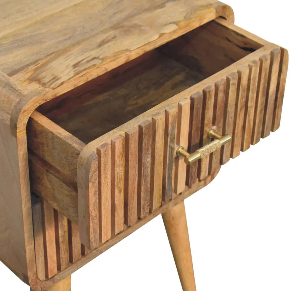 A rustic wooden t-bar ridged bedside nightstand with slatted drawer front and brass handle for bedroom use