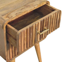 A rustic wooden t-bar ridged bedside nightstand with slatted drawer front and brass handle for bedroom use