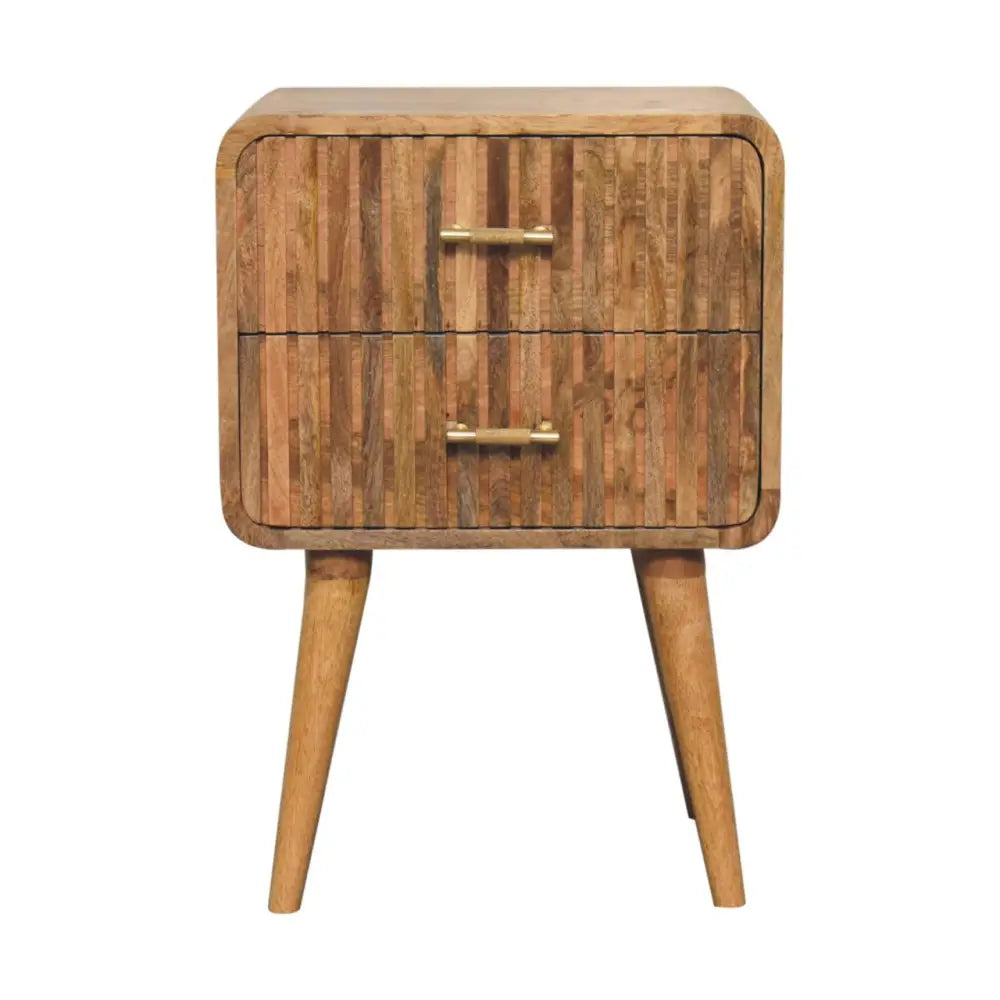 A rustic wooden t-bar ridged bedside nightstand with two drawers and brass handles in warm brown tones