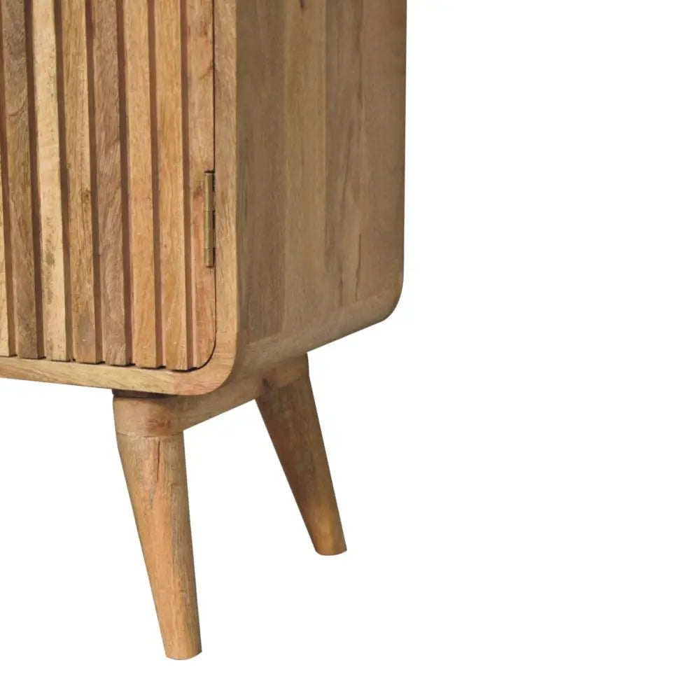 A mid-century modern wooden t-bar ridged cabinet with vertical slats and tapered legs for stylish storage