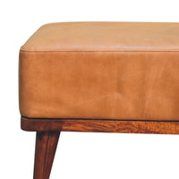 Tan buffalo leather ottoman with a wooden base and tapered legs perfect as a footstool or extra seating