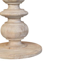 The bellis marble accent table features a light distressed wood pedestal base made of solid mango wood with ornate tiered design