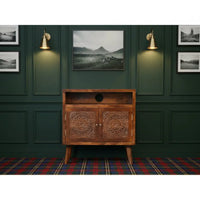 Brown wooden tova open shelf cabinet with intricate circular carvings and round cutout on open shelf doors