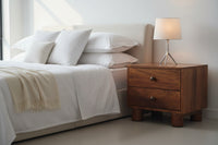 Brown wooden tula 2 drawer nightstand with round metal knobs on solid mango wood and cylindrical block legs