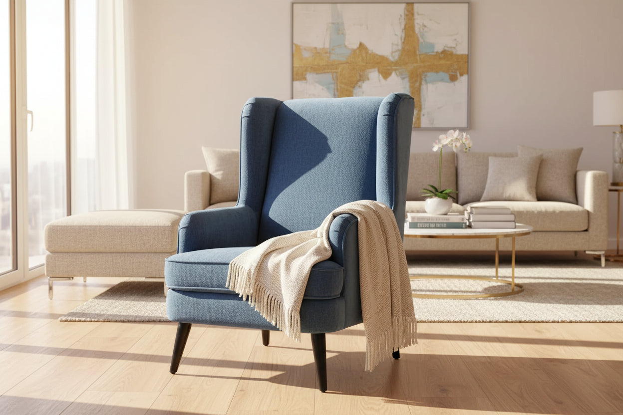 A vellis wingback armchair in navy blue textured velvet with sleek black tapered legs for stylish seating