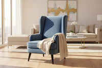 A vellis wingback armchair in navy blue textured velvet with sleek black tapered legs for stylish seating