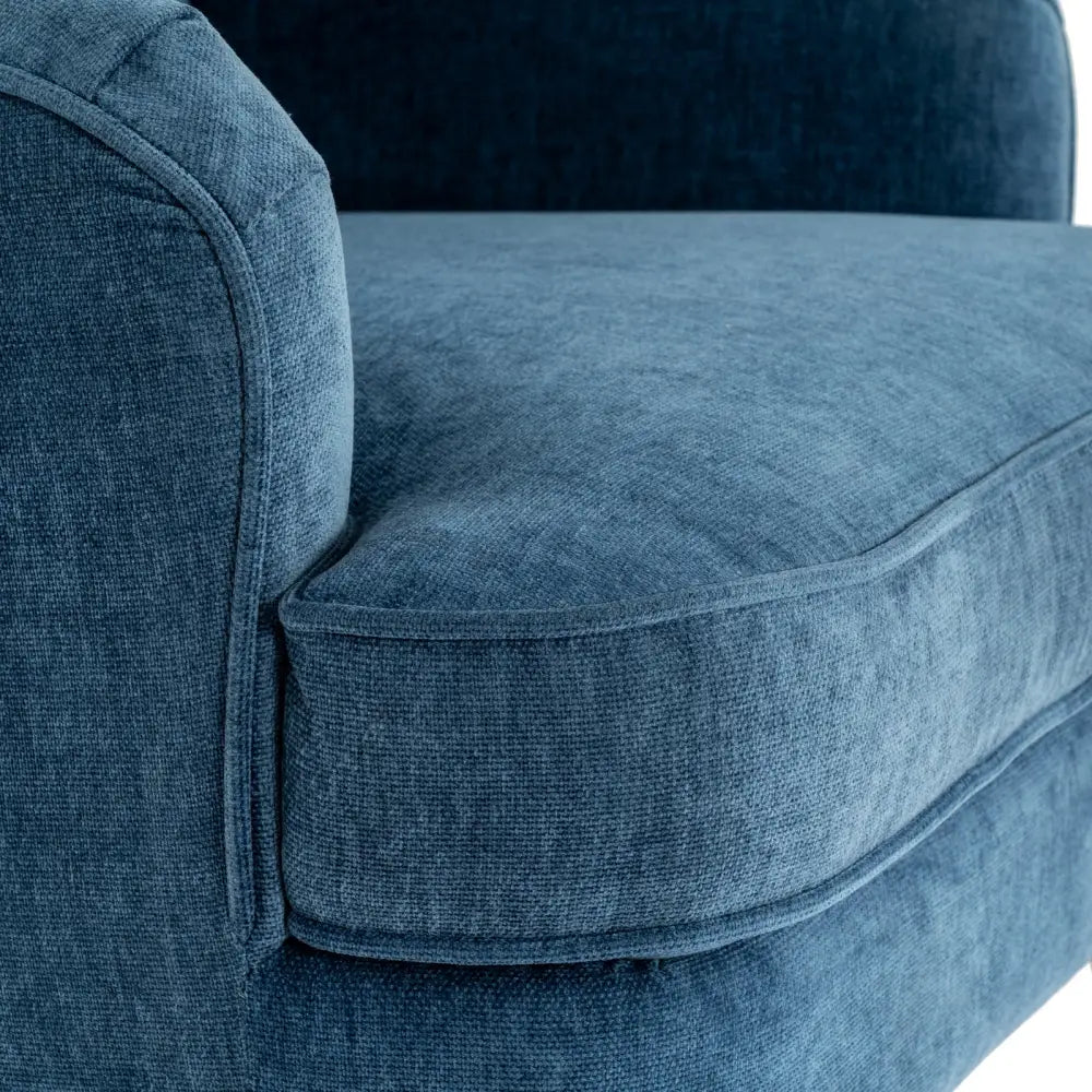 Vellis wingback armchair in deep navy blue textured fabric with plush cushioned velvet seating for cozy comfort