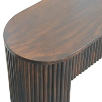 Dark brown wooden console table with smooth oval top and vertical fluted legs matching velvet mocha fluted bench style