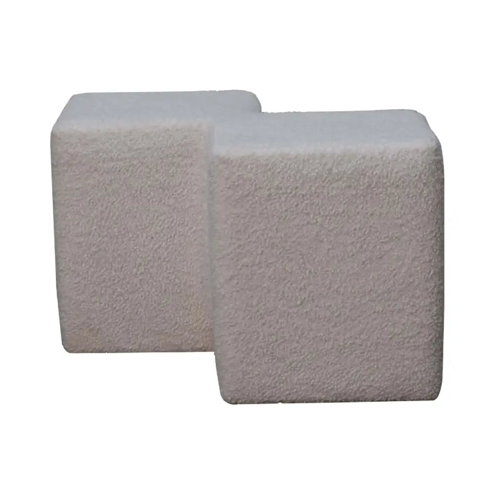 White boucle twin footstool with two light gray textured concrete cubes arranged in an l-shape
