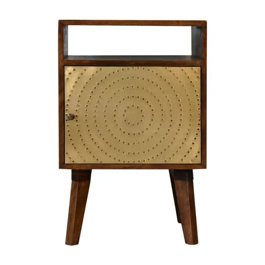 A mid-century modern zen bedside with dark wood frame and gold metal door featuring concentric rivet patterns