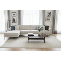 Light gray fabric zephra three seater sofa with navy and beige throw pillows and matching footstool
